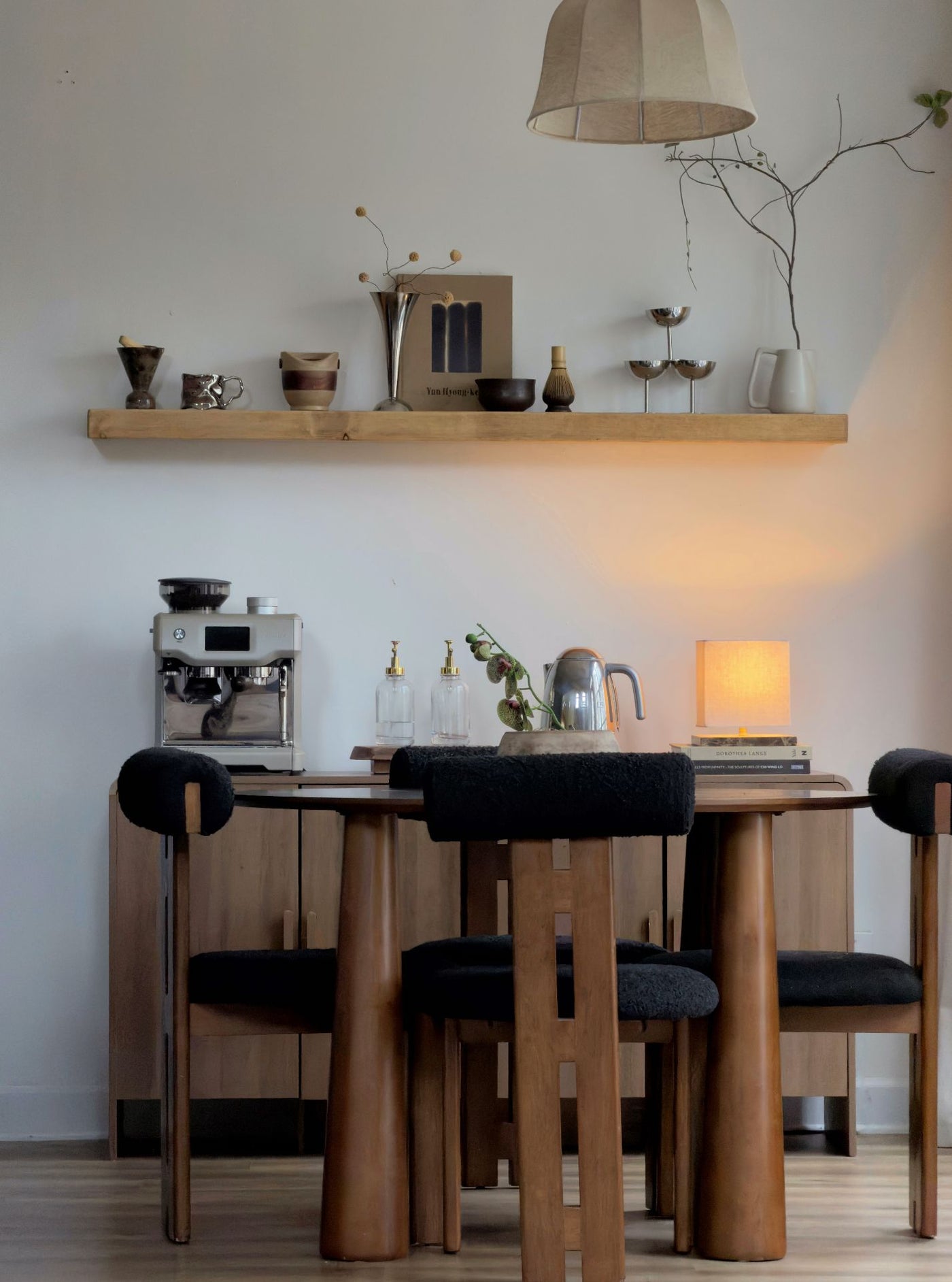 floating shelf above coffee bar showing dining table and chairs