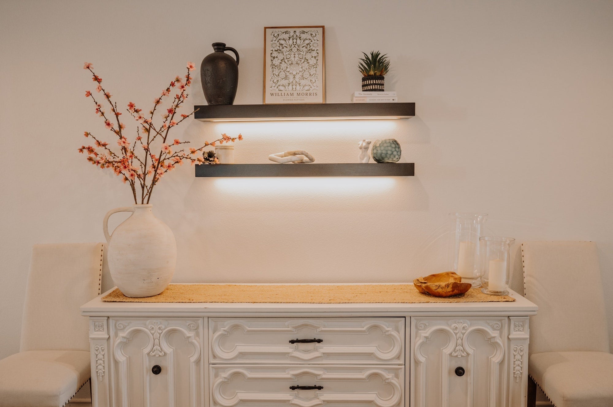 2 black led floating shelves at entry way in home