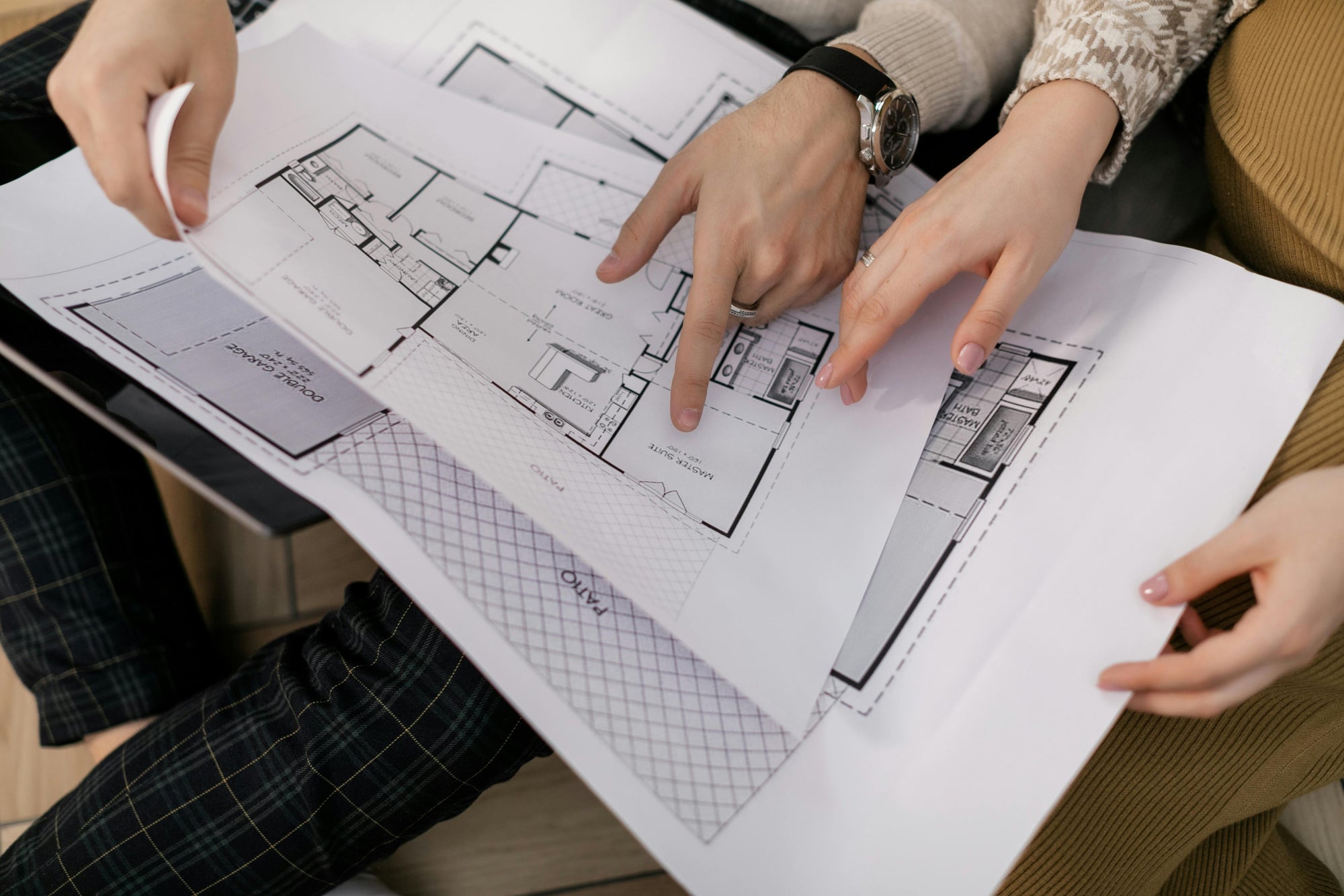 two people reviewing floor plans