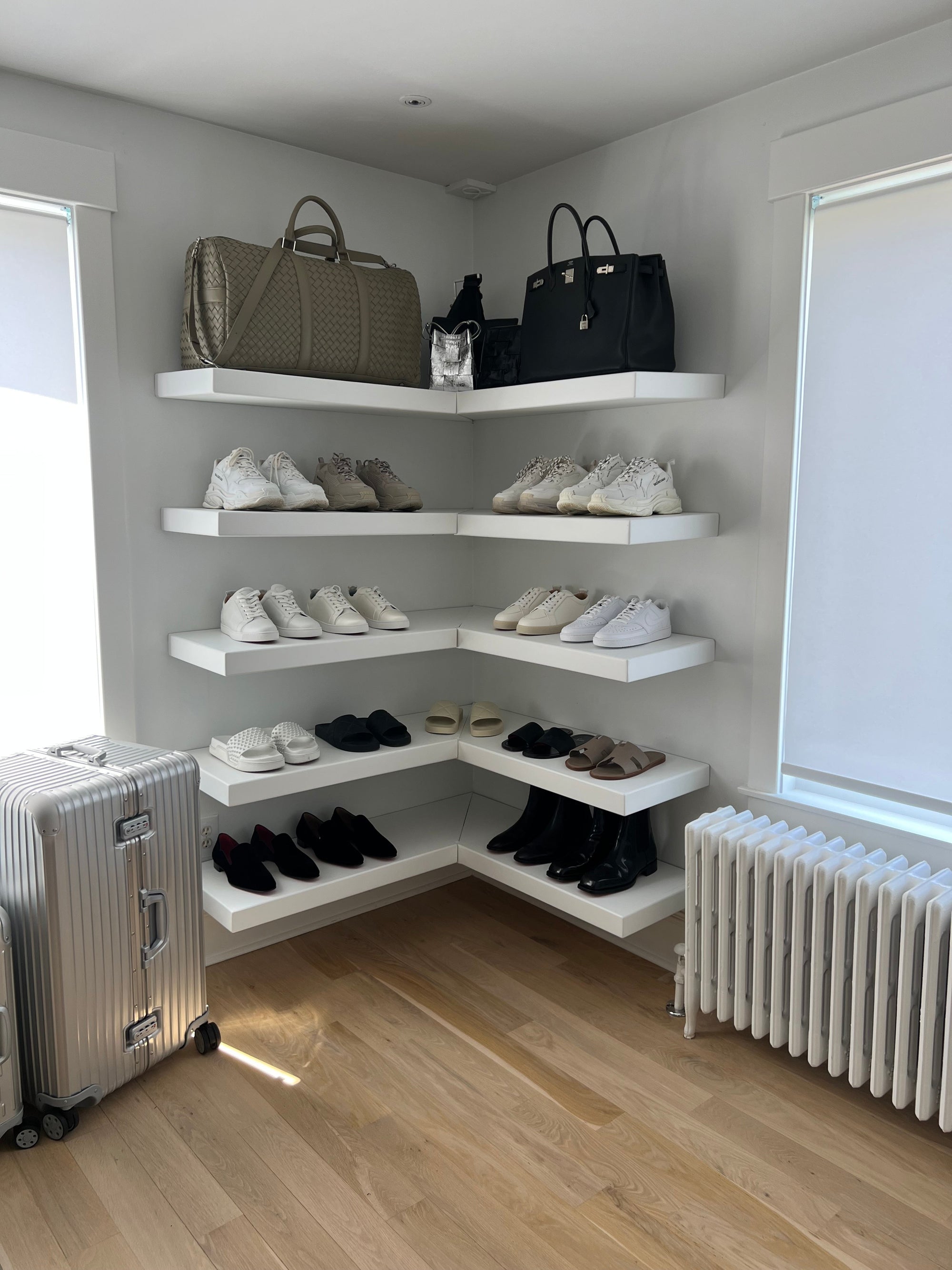 white floating shelves with shoes organized on them