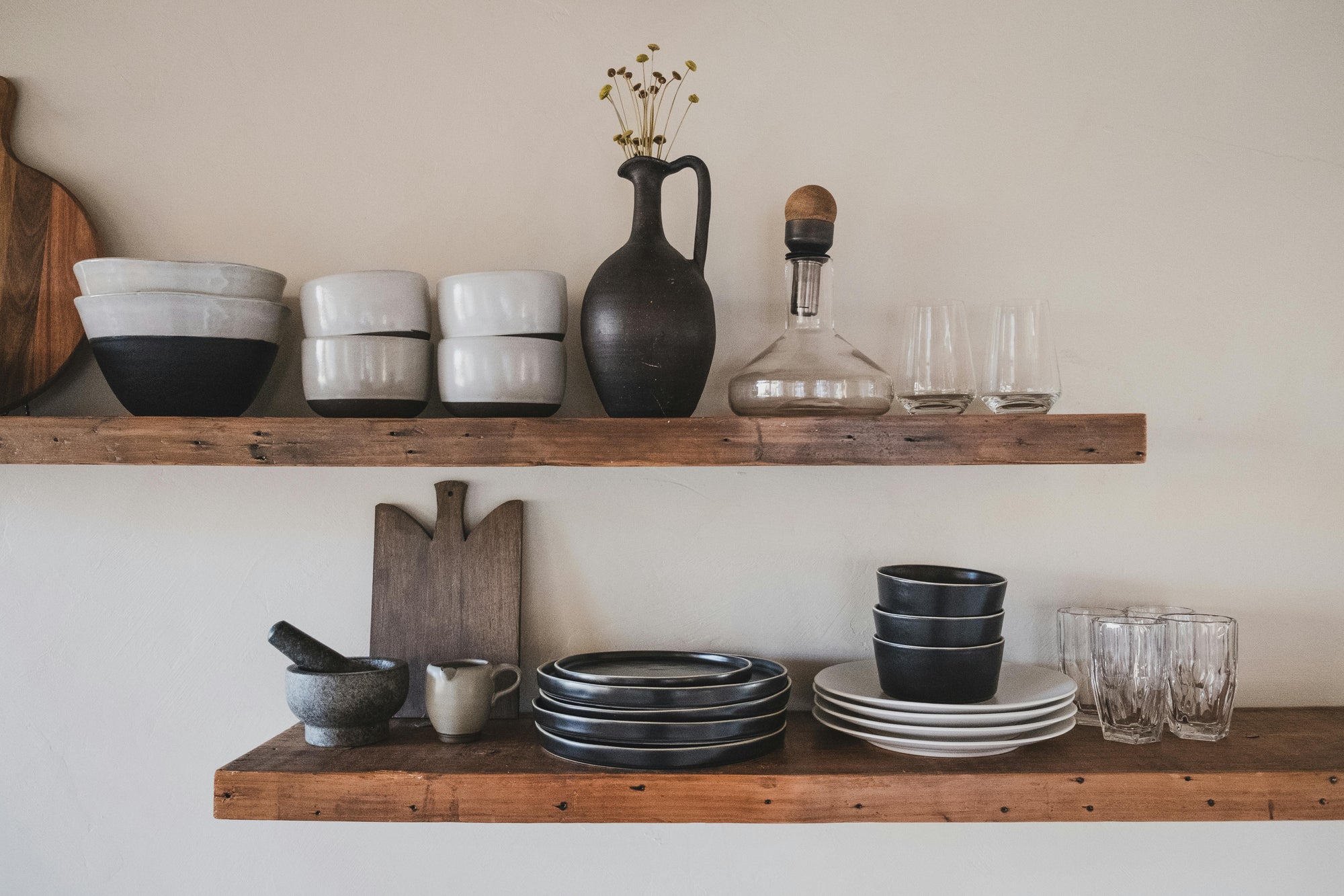 rustic wood floating shelves with plates and dishes on them