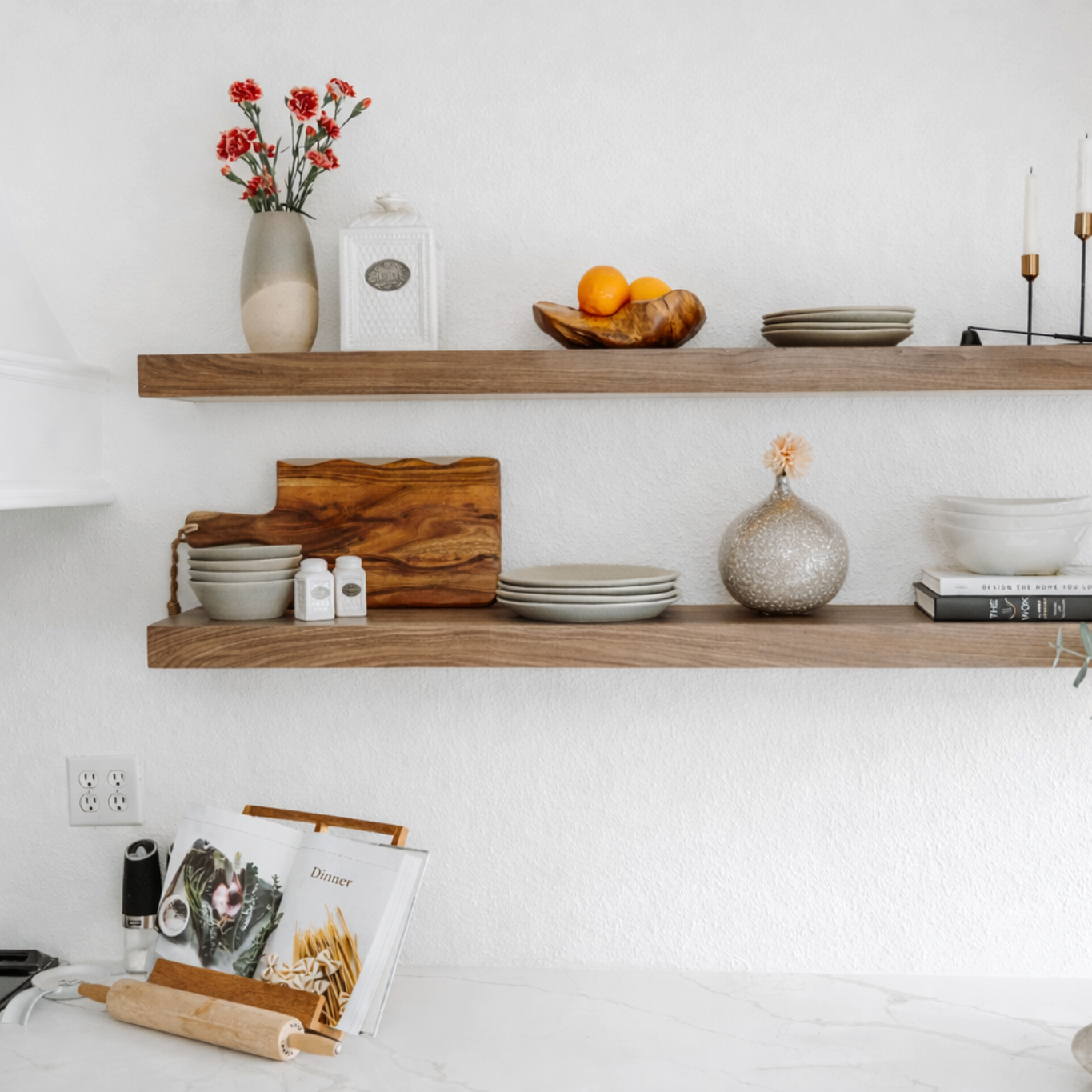 Wooden shelves with decorative items against a white wall