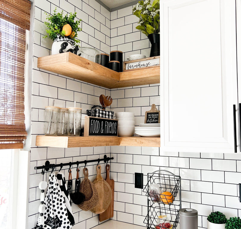 A knotty pine corner floating shelf in a rustic style, mounted on a white wall in a kitchen setting. 